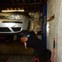 Lewis working on a customers' car